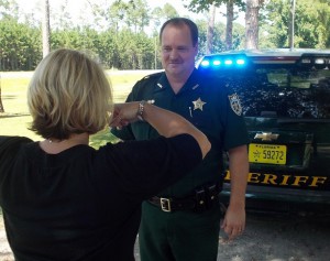 A woman performing a DUI test for an officer