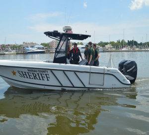Five people in a police boat on the water