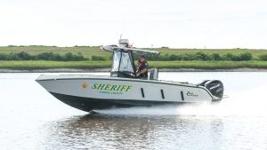 Two officers drive a police boat
