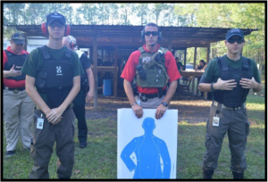 Three men posing at the explorer shooting range