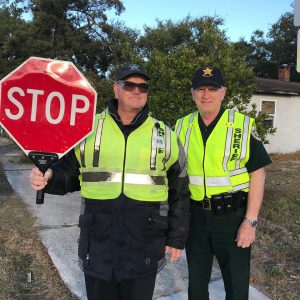 crossing guards holding stop sign