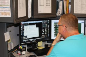 Man in front of multiple computer screens