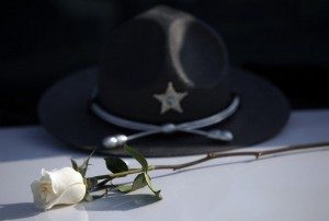 A sheriff's hat with a white rose