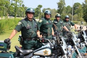 Four officers posing with their motorcycles